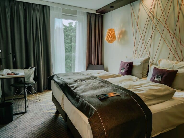 a hotel room with a bed and a window